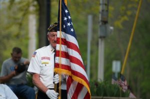 A veteran holds an American flag